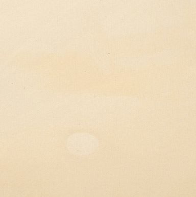 Close up image of a surface that developed a yellow cast in aging paint.