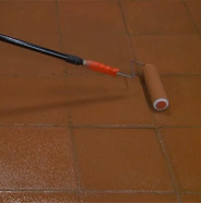 Rolling out stain evenly with a roller