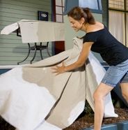 Image of lady removing drop cloths