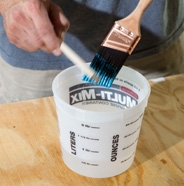 Cleaning paint brush with a paint comb.