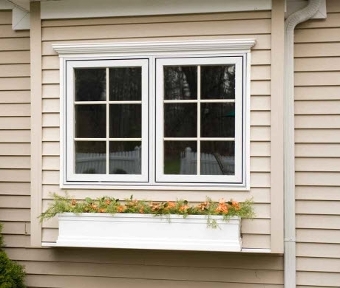 Exterior shot of windows with flower pot below