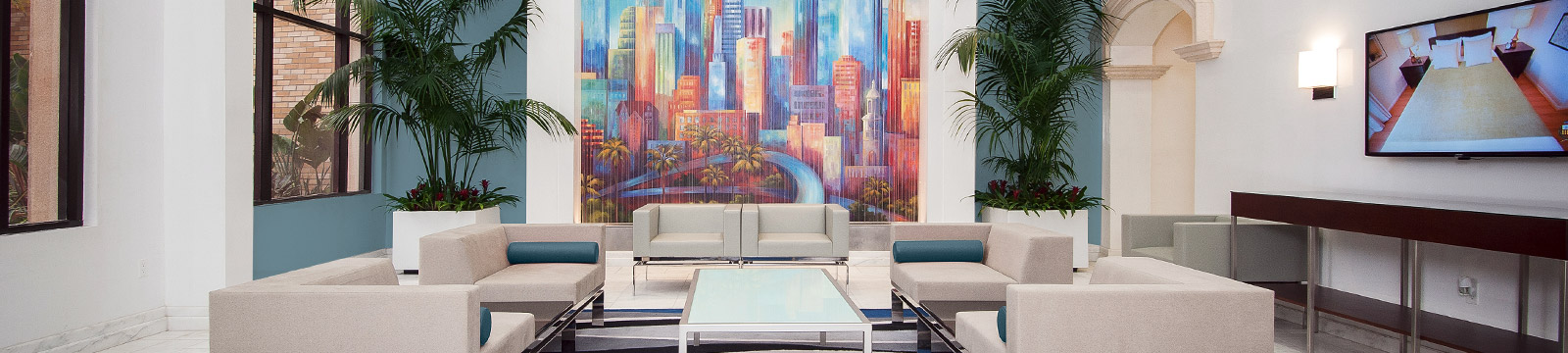 Large image of a lobby floor of a hotel with comfortable chairs.