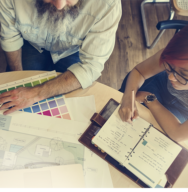 3 people sitting at a table discussing paint colors - for mobile