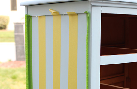 Dresser side with painter’s tape masking for stripes