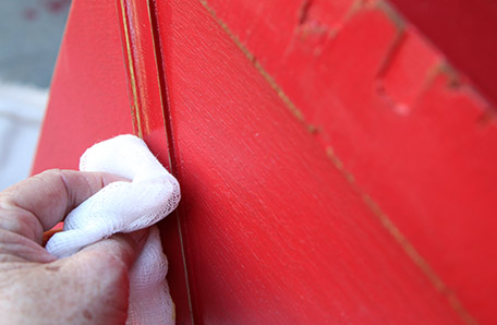 furniture wax being applied with rag to chest