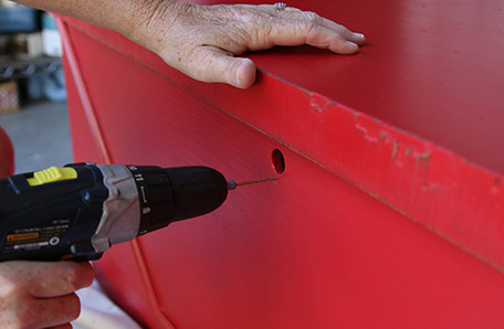 holes being drilled into chest for new key plate