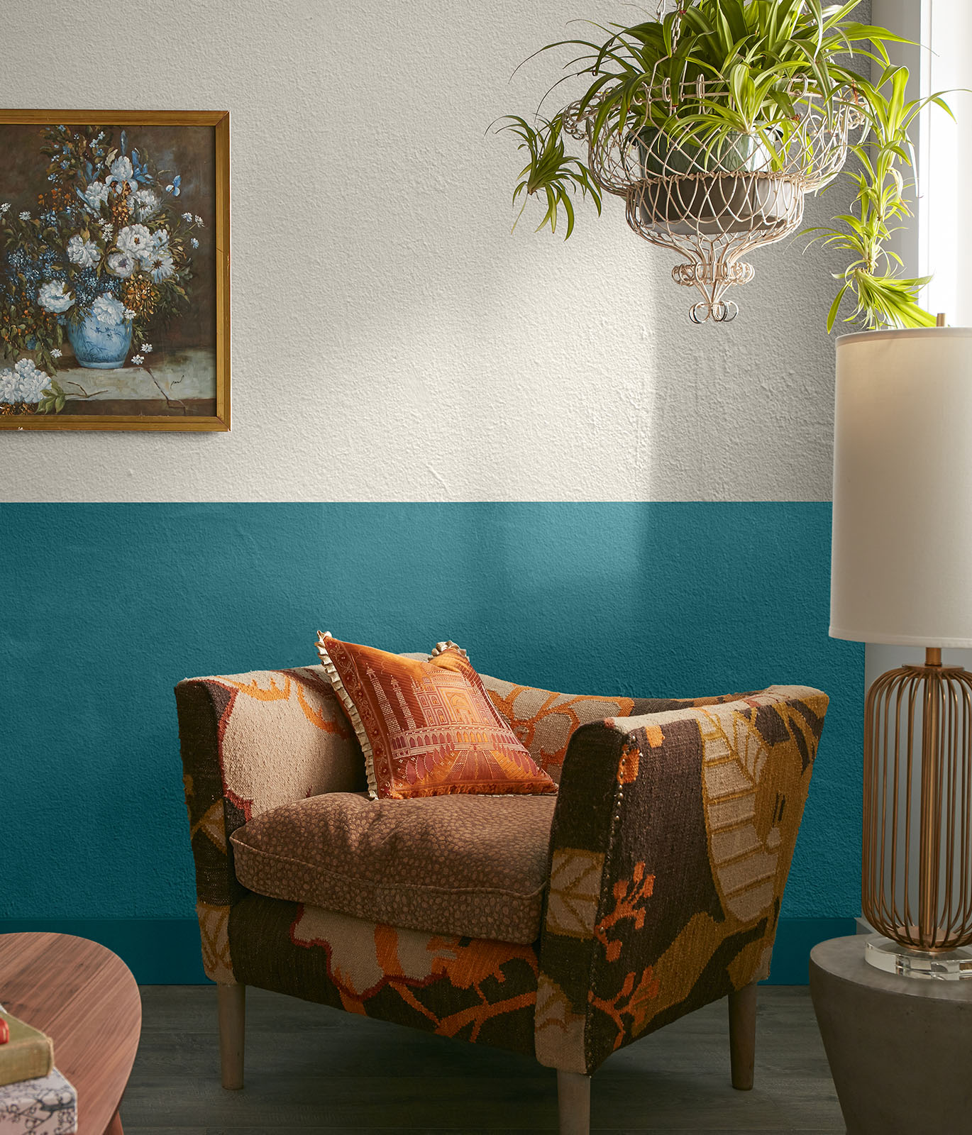 A sitting area with the walls painted in white and blue. A comfy chair sits in the corner. The mood is buoyant.