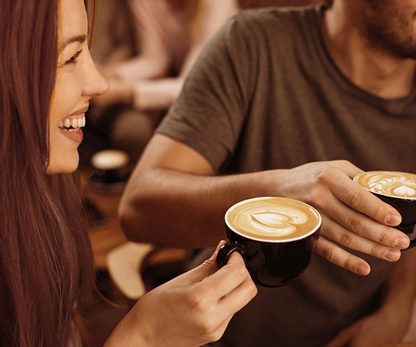 Two people sharing a cup of coffee.